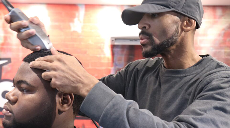 Tremayne “Trobiz” Howe cuts a customer’s hair at his Fademasters barbershop.