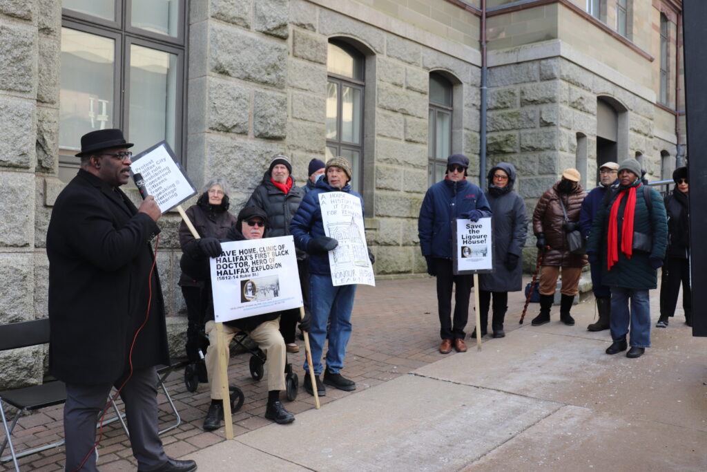 Artist and historian David Woods speaks outside City Hall where people gathered as Halifax regional council voted on heritage designation for the former home of Dr. Clement Ligoure. Credit: Matthew Byard