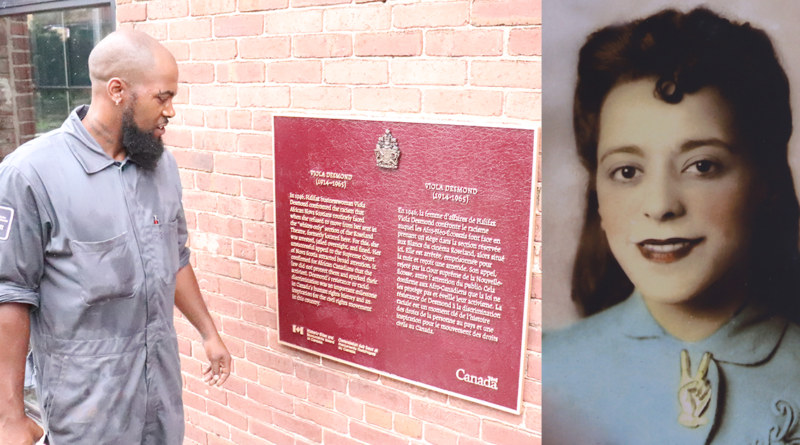 Bobby Taylor from Parks Canada looks at his work after installing a commemorative plaque honouring Viola Desmond on the side of the former Rosland Theatre where Desmond was arrested in Nov. 1946. Photo: Matthew Byard.